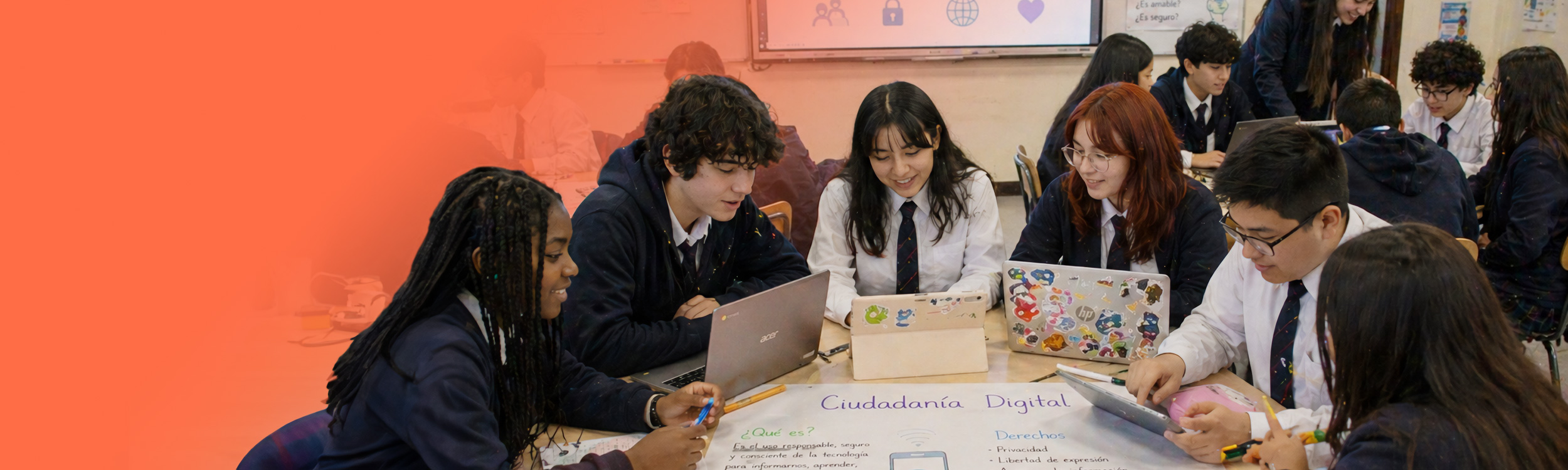 Grupo de estudiantes de educación media trabajando en conjunto, utilizando computadores y tablets.