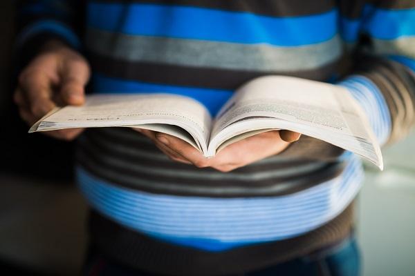 Niño con un libro abierto en sus manos. 